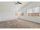 Bedroom with high ceilings, carpeted floor, fan, and multiple windows overlooking the mountain at 15825 S 1St Ave, Phoenix, AZ 85045