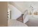 Bright entryway featuring high ceilings, tile floors, and a carpeted staircase with white railings at 15825 S 1St Ave, Phoenix, AZ 85045