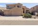 Warm, tan two-story home featuring a tile roof, a three-car garage, and desert landscaping at 15825 S 1St Ave, Phoenix, AZ 85045