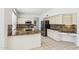 Bright kitchen featuring white cabinetry, granite countertops, stainless steel appliances, and tile floors at 15825 S 1St Ave, Phoenix, AZ 85045