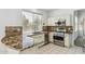 Bright kitchen featuring white cabinetry, granite countertops, stainless steel appliances, and tile floors at 15825 S 1St Ave, Phoenix, AZ 85045
