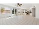 Spacious living room featuring tile floors, bright lighting, and glass doors leading to a pool at 15825 S 1St Ave, Phoenix, AZ 85045