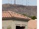 Close up of a red-tiled rooftop against a backdrop of hills and cell towers at 15825 S 1St Ave, Phoenix, AZ 85045