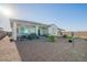 The backyard has a covered patio area, desert landscaping, and a privacy wall at 15843 S 177Th Ave, Goodyear, AZ 85338