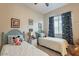 Charming ' bedroom with two twin beds, playful decor, and a cozy atmosphere at 15843 S 177Th Ave, Goodyear, AZ 85338