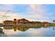 View of the community clubhouse reflected in the lake at 15843 S 177Th Ave, Goodyear, AZ 85338
