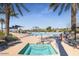 Tranquil community hot tub with nearby pool, palm trees, and lounge seating at 15843 S 177Th Ave, Goodyear, AZ 85338