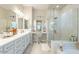Luxurious primary bathroom with double vanities, a walk-in shower, and elegant fixtures at 15843 S 177Th Ave, Goodyear, AZ 85338