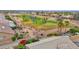 Scenic aerial view of a well-manicured golf course community with lush green fairways and landscaped homes at 16215 W Indianola Ave, Goodyear, AZ 85395