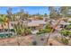 A beautiful home with mature trees and desert landscaping; aerial view highlights the outdoor space and community at 16215 W Indianola Ave, Goodyear, AZ 85395