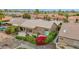 A landscaped home with a covered patio and vibrant desert yard; aerial view emphasizes the community setting and outdoor charm at 16215 W Indianola Ave, Goodyear, AZ 85395