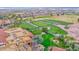 Expansive aerial view showcases the golf course, residential area, and community amenities with lush landscaping at 16215 W Indianola Ave, Goodyear, AZ 85395