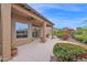 Beautiful back patio with vibrant flowering plants, ample seating area, and a serene outdoor ambiance at 16215 W Indianola Ave, Goodyear, AZ 85395