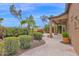 A covered back patio opens to a landscaped yard, offering a tranquil outdoor living space with lush greenery and desert foliage at 16215 W Indianola Ave, Goodyear, AZ 85395
