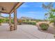 Inviting back patio with meticulous landscaping and mature trees, creating a private and relaxing outdoor space at 16215 W Indianola Ave, Goodyear, AZ 85395