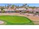 This landscaped backyard overlooks the community golf course and features a cozy patio and lush desert landscaping at 16215 W Indianola Ave, Goodyear, AZ 85395
