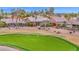 This landscaped backyard overlooks the community golf course and features a cozy patio and lush desert landscaping at 16215 W Indianola Ave, Goodyear, AZ 85395