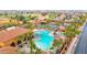 Aerial view of community pool, hot tub, palm trees, lounge chairs, and desert landscape at 16215 W Indianola Ave, Goodyear, AZ 85395