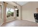 Bright dining area with large windows, neutral walls, and tile flooring overlooking tropical foliage at 16215 W Indianola Ave, Goodyear, AZ 85395