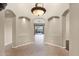 Foyer showcasing tiled floors, arched passageways, and a chandelier offering natural light and inviting ambiance at 16215 W Indianola Ave, Goodyear, AZ 85395