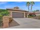 Home exterior showcasing the garage, desert landscaping, and a private mailbox with palm trees in the background at 16215 W Indianola Ave, Goodyear, AZ 85395