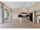 Kitchen and living area featuring tiled flooring, large windows, and modern fixtures at 16215 W Indianola Ave, Goodyear, AZ 85395