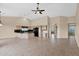 Open floor plan featuring a modern kitchen with a large island, black appliances and tan colored walls at 16215 W Indianola Ave, Goodyear, AZ 85395