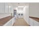 Well-lit laundry room with modern washer and dryer, ample counter space, and storage cabinets at 16215 W Indianola Ave, Goodyear, AZ 85395