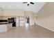 Spacious open-concept living area featuring tiled flooring and a partial view of the front entryway at 16215 W Indianola Ave, Goodyear, AZ 85395