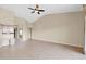Large living area with open concept design, tiled floors and tan colored walls at 16215 W Indianola Ave, Goodyear, AZ 85395