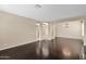 Open concept living room with dark hardwood flooring and an elegant chandelier fixture at 16215 W Indianola Ave, Goodyear, AZ 85395