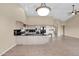 Open living space with kitchen island, appliances, tiled floors and neutral walls at 16215 W Indianola Ave, Goodyear, AZ 85395