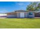 Backyard showcases green grass, with a structure that has a door at 1660 W 7Th Pl, Mesa, AZ 85201