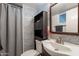 Bathroom features unique mosaic tile, stylish fixtures, and efficient storage at 1660 W 7Th Pl, Mesa, AZ 85201
