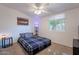 Bright bedroom featuring natural light, a ceiling fan, and comfortable furnishings at 1660 W 7Th Pl, Mesa, AZ 85201