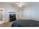 Bedroom with a ceiling fan, television, closet, and access to an en-suite bathroom at 1660 W 7Th Pl, Mesa, AZ 85201