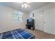 Cozy bedroom featuring a ceiling fan, a TV, and a window offering natural light at 1660 W 7Th Pl, Mesa, AZ 85201