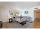 Spacious living room featuring a plush gray sofa, a large rug, and bright natural light at 1660 W 7Th Pl, Mesa, AZ 85201