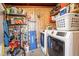 Functional utility room with wood paneled walls, shelving, and modern washer and dryer at 1660 W 7Th Pl, Mesa, AZ 85201