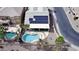 Aerial view showcasing backyard featuring pool, firepit, and solar panels for energy efficiency at 17705 N Vera Cruz Ave, Maricopa, AZ 85139