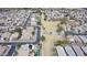 Community aerial view showcasing well-maintained streets and a central park with a playground at 17705 N Vera Cruz Ave, Maricopa, AZ 85139