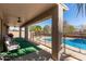 Covered patio with seating area overlooking a fenced pool at 17705 N Vera Cruz Ave, Maricopa, AZ 85139