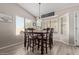 Cozy dining area with wood flooring, large windows, and a decorative sign at 17705 N Vera Cruz Ave, Maricopa, AZ 85139