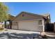 Single-story home featuring a two car garage, neutral color palette, and well maintained desert landscaping at 17705 N Vera Cruz Ave, Maricopa, AZ 85139