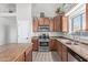 Functional kitchen with stainless steel appliances and warm-toned cabinetry at 17705 N Vera Cruz Ave, Maricopa, AZ 85139