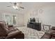 Spacious living room featuring vaulted ceilings, hardwood floors, patio access, and comfortable leather furniture at 17705 N Vera Cruz Ave, Maricopa, AZ 85139