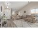 Bright living room with vaulted ceilings, wood-look floors, neutral color palette, and a cozy seating area with a plush rug at 17705 N Vera Cruz Ave, Maricopa, AZ 85139