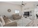 Bright living room with vaulted ceilings, wood-look floors, and a cozy seating area with a plush rug at 17705 N Vera Cruz Ave, Maricopa, AZ 85139
