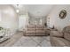 Bright living room with vaulted ceilings, wood-look floors, neutral color palette, and a cozy seating area with a plush rug at 17705 N Vera Cruz Ave, Maricopa, AZ 85139
