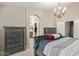Elegant main bedroom showcasing a decorative bed frame and arched doorway to bath at 17705 N Vera Cruz Ave, Maricopa, AZ 85139
